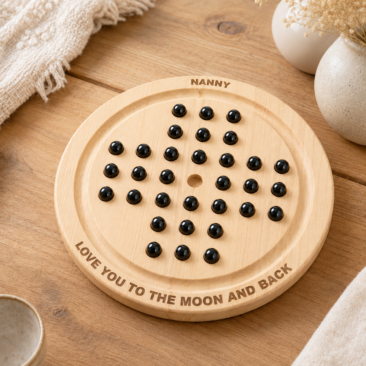 Personalised wooden solitaire board game styled on a wooden table